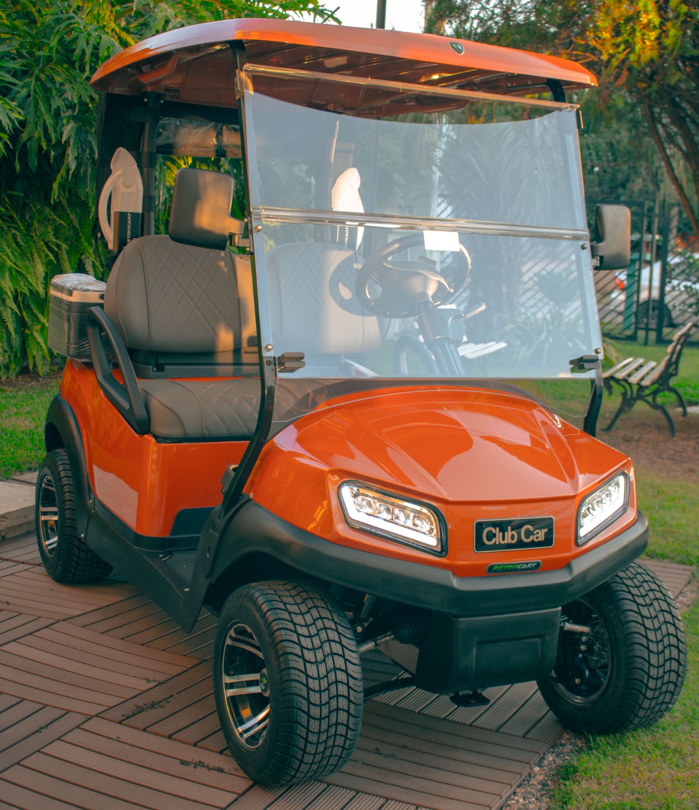 A golf cart parked outdoors with resort and palm trees in the background, perfect for vacation vibes.